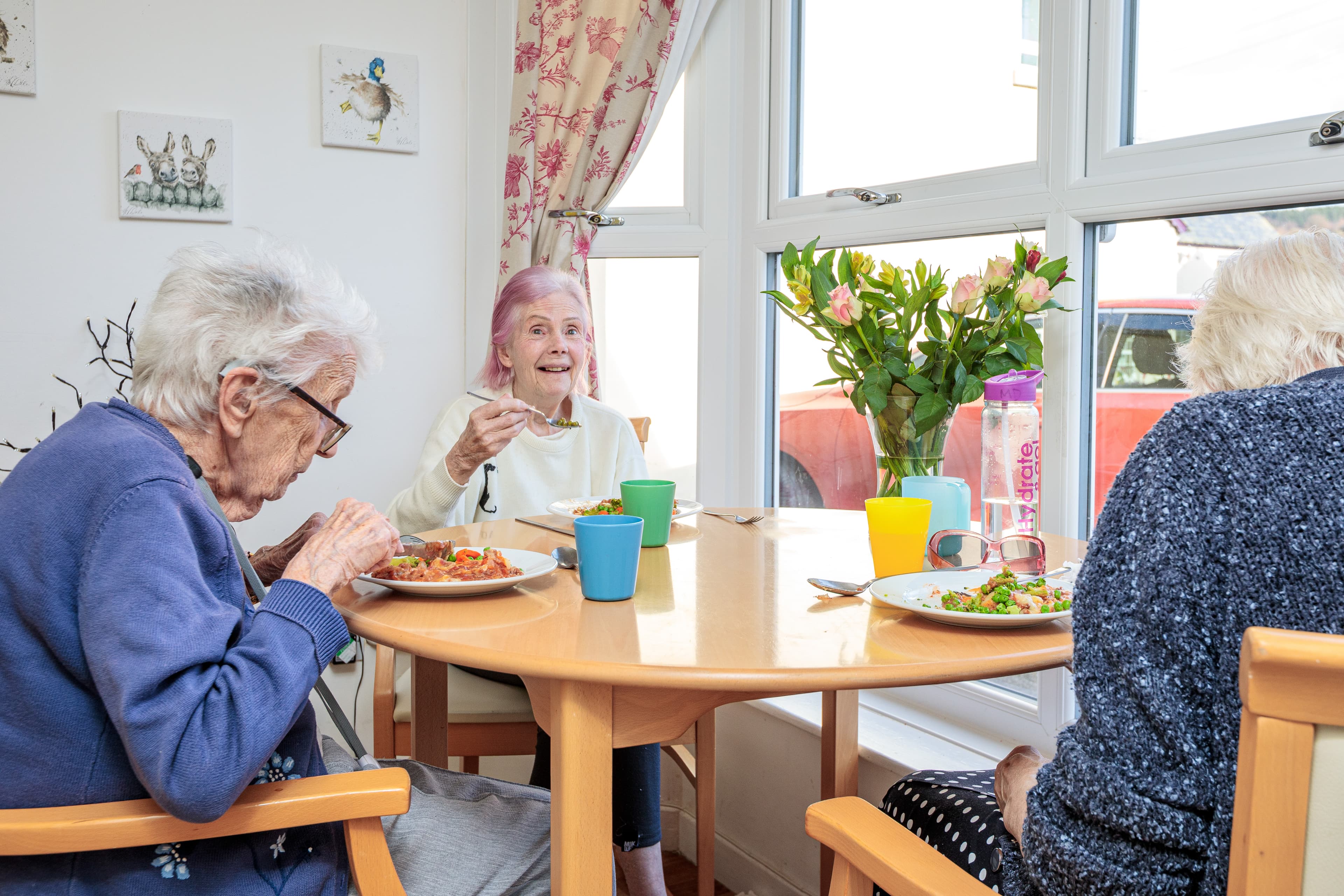 Residents chatting at the dining table